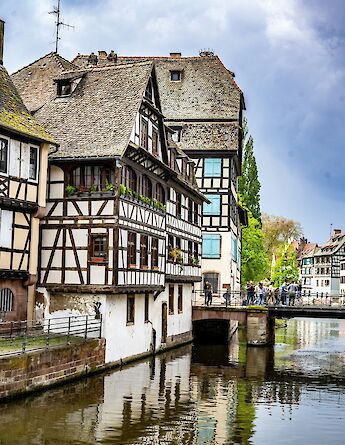 Half-timbered houses by the river, Strasbourg bike tour, France. Jacques Dillies@Unsplash