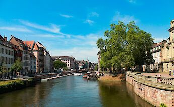 Blue skies above the canal, Strasbourg bike tour, France. Sebastian Piazzi@Unsplash
