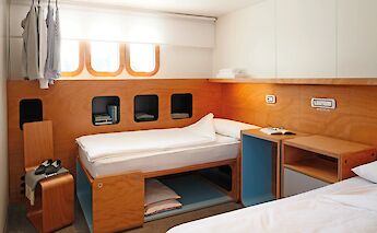 A bright and comfortable twin cabin, thoughtfully designed with smart storage and a warm, modern…