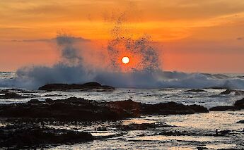 Pacific sunset over the rocky shores of Guanacaste. cc-Heather