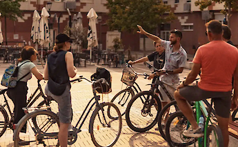 Listening to the bike tour guide in Tirana, Albania. CC:TO