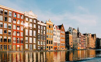 Iconic canal houses along the Amsterdam waterfront. JavierM@unsplash
