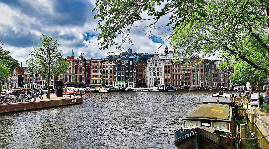 Classic canal houses along an Amsterdam waterway. memorycatcher@pixabay