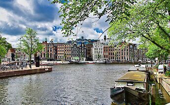 Classic canal houses along an Amsterdam waterway. memorycatcher@pixabay