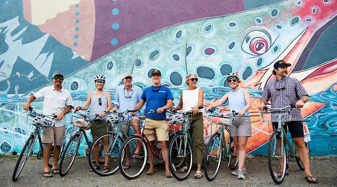 Tour group at a mural on the Bozeman bike tour, Montana, USA. CC:TO