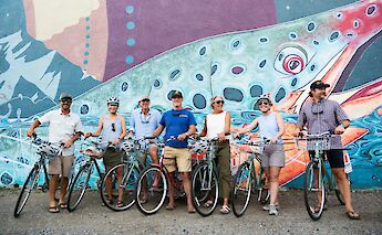 Tour group at a mural on the Bozeman bike tour, Montana, USA. CC:TO