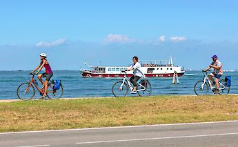 Cycling beside the water with the barge nearby. toGL