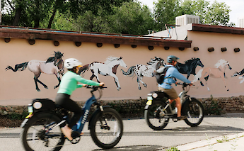 E-bike tour past a horse mural in Taos, New Mexico, USA. CC:TO